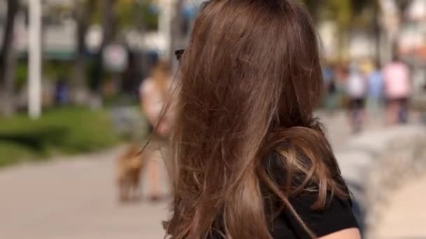 Młoda kobieta relaksuje się na promenadzie Miami Beach w słoneczny dzień — Wideo stockowe