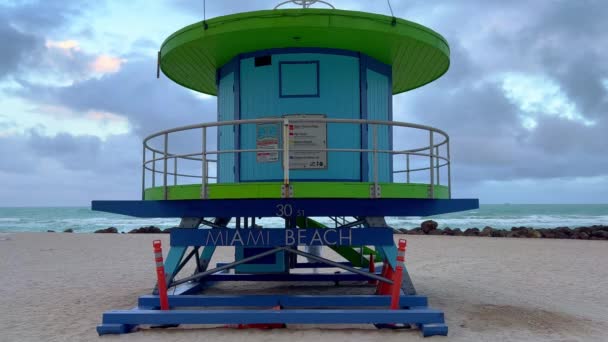 Typowe kolorowe domy ratowników na plaży Miami - MIAMI, Stany Zjednoczone - LUTY 20, 2022 — Wideo stockowe
