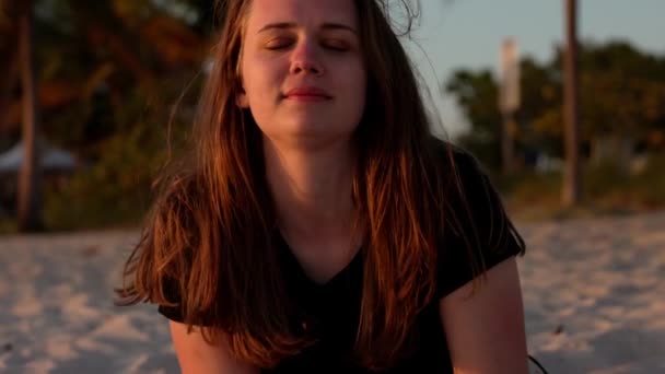 Ευτυχισμένη γυναίκα απολαμβάνει το υπέροχο ηλιοβασίλεμα στην παραλία του Μαϊάμι — Αρχείο Βίντεο