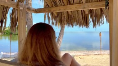 Karayip sahilinde dinlenen genç bir kadın.