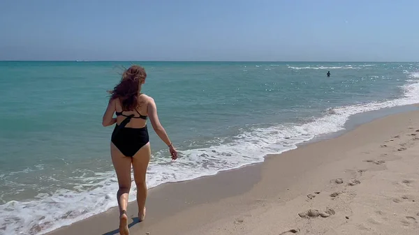 Futás át a strandon kék óceán víz - Miami Beach — Stock Fotó