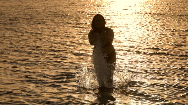 Schöne Frau genießt das warme Meerwasser in Miami bei Sonnenuntergang — Stockfoto