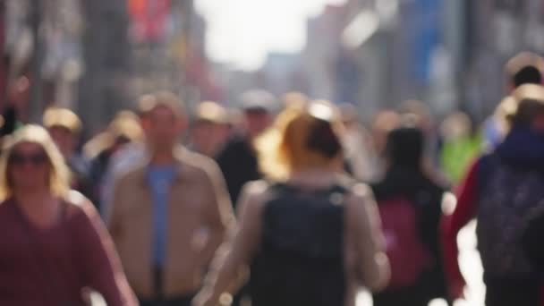 Crowd of people walking through a busy pedestrian zone - Grafton Street Dublin in slow motion - DUBLIN, IRELAND - APRIL 20, 2022 — Stock Video