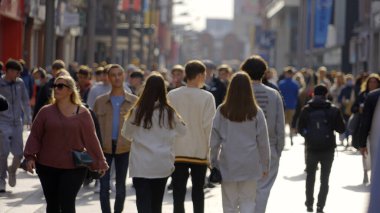 Crowd of people walking through a busy pedestrian zone - Grafton Street Dublin in slow motion - CITY OF DUBLIN, IRELAND - APRIL 20, 2022