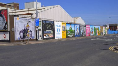 The famous Wall Murals of Belfast on the houses and Peace Wall - BELFAST, UNITED KINGDOM - APRIL 25, 2022