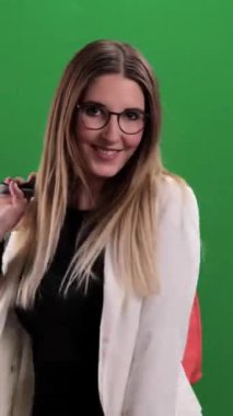Young pretty woman with shopping bags on shopping tour - studio photography - Vertical video