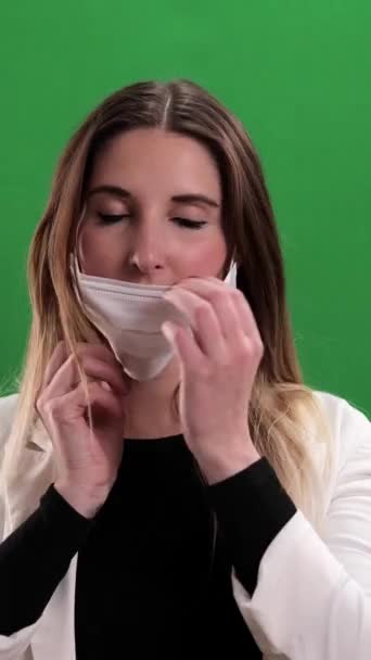 Young Woman Puts Medical Face Mask Studio Photography Vertical Video — Vídeos de Stock