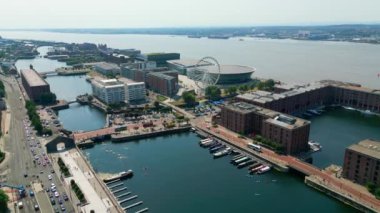 Albert Dock and Ferris Wheel at Mersey River Liverpool - LIVERPOOL, UNITED KINGDOM - AUGUST 16, 2022