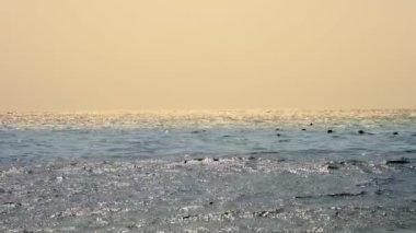 Deniz manzarası. Gökyüzü ve deniz. Güneş ışığında dalgalar, güneşte parlayan sular. Denizde güneşli bir gün