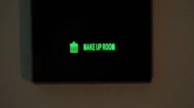 make up room. close-up. the sign is lit in green. electronic plate. External indicator. a digital board with an inscription - make up room. in the hotel room
