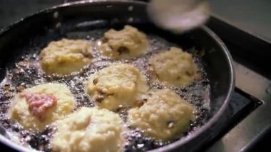 Patates kızartması. Patates köftesi. Yemek pişirmek. Patates keki, zuela. Açık büfe restoran mutfağı. Yakın plan. Aşçı çıtır patates kızartması yapıyor, kızgın yağda kızarıyor..