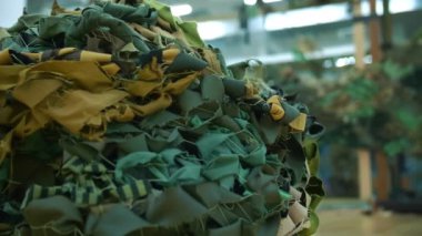 camouflage net. military. netting. protective camouflage nets, made of green ribbons and khaki fabric shreds, for the military needs of the army. volunteering.