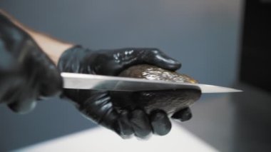 cooking. Culinary. avocado. close-up. the cook cuts a fresh avocado into half, slices. Food