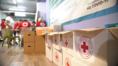 Red Cross. Charity Warehouse. covid-19 vaccination. volunteers distribute humanitarian aid for low-income and poor people during the coronavirus pandemic.