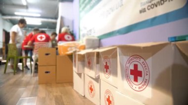 Red Cross. Charity organization. volunteers distribute humanitarian aid for low-income and poor people, refugees and migrants. Volunteer Warehouse