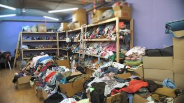 warehouse. Community Volunteer Center. Shelves with donated things and clothes for refugees and migrants, low-income and poor people.