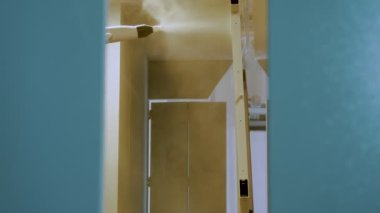 Airless Spray Painting. Industrial painting process at painting factory facility.