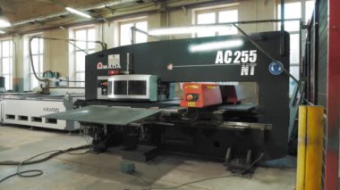 CHERKASSY, UKRAINE, JULY 19, 2022: metal cutting. High precision cutting machine metal part. modern machine with CNC fiber laser is cutting patterns on sheet metal plate.