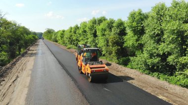 Aerial view on repair of a highway, the process of laying a new asphalt covering, Road construction works. High quality photo