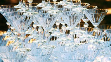 close-up, crystal champagne glasses stand on a hill, on each other, for a waterfall of champagne. High quality photo