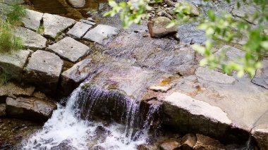 waterfall, a small mountain alpine Creek, river. clear, clean, drinking water. summer day, in the forest, in the mountains, the Alps. High quality photo