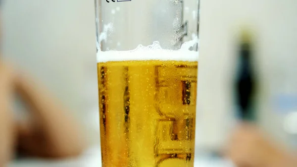 close-up, a pint glass with cold, light beer. water droplets on the glass, the walls of the beer glass. High quality photo