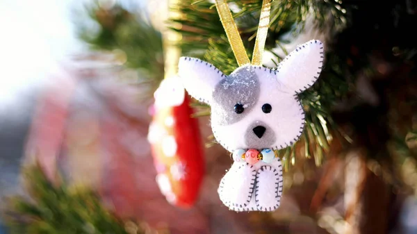 close-up, Christmas toys hanging on a snow-covered tree branch. winter, frosty, snowy, sunny day. High quality photo