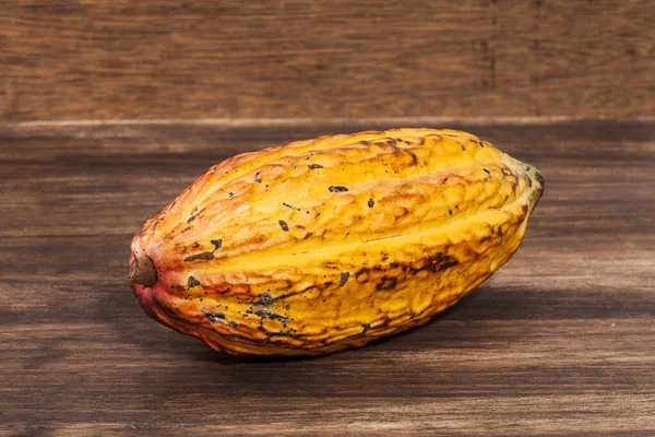 Theobroma Cacao - Organic Cocoa Fruit Of The Cocoa Tree; Photo On Wooden Background