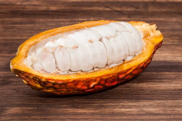 Theobroma Cacao - Organic Cocoa Fruit Of The Cocoa Tree; Photo On Wooden Background