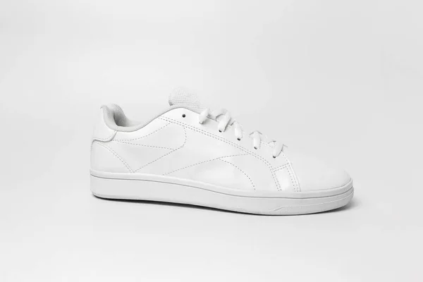 Side view of white sneaker isolated on white background for cutting out. Sportive pair of shoes for mockup. Fashionable stylish sports casual shoes.