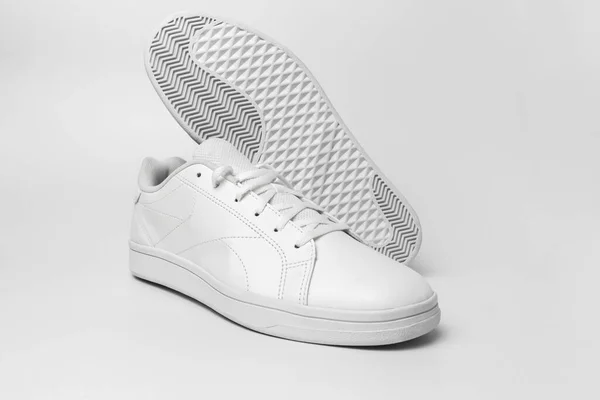 New pair of white sneakers isolated on white background for cutting out. Sportive pair of shoes for mockup. Fashionable stylish sports casual shoes.