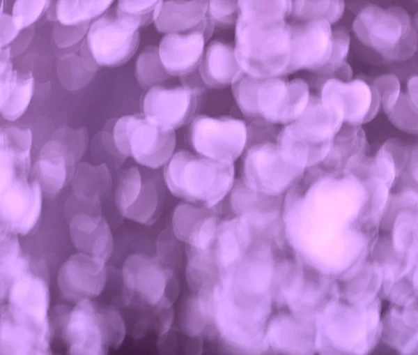 Purple bokeh background with heart shapes