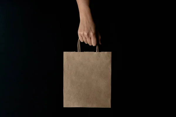 Hand Carrying Kraft Shopping Bag Black Background Right Hand — Stock Photo, Image