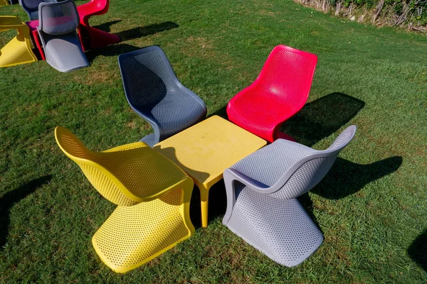 colorful chairs and table in the garden