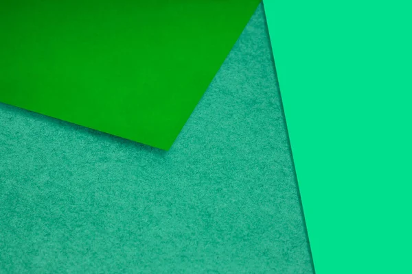 Plain and Textured neon yellow green.papers randomly laying to form M like pattern and triangle for creative cover design idea
