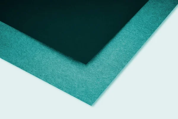 abstract blue green background with lines forming triangle looks like side view of an open book plain vs textured cover