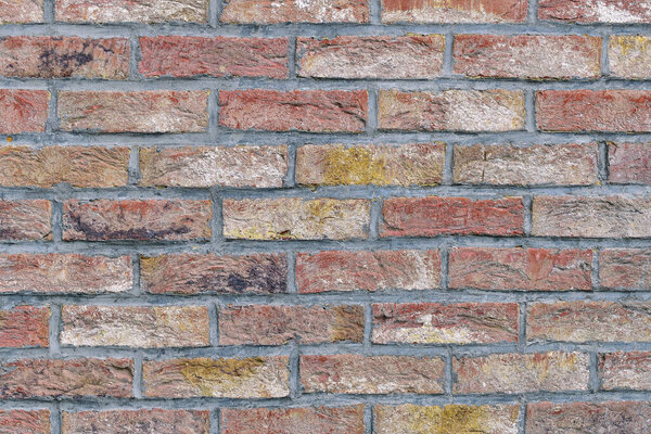 Внешняя кирпичная каменная стена с серыми соединениями закрывает заднюю текстуру