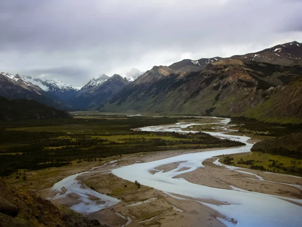 River running through green valley in mountain landscape, Cerro Torre trail, El Chalten, Argentina, Patagonia