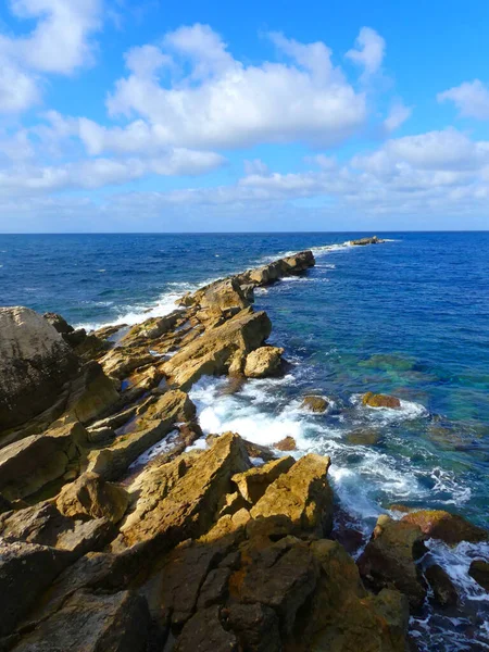 Beautiful coastal landscape with rocks and waves.