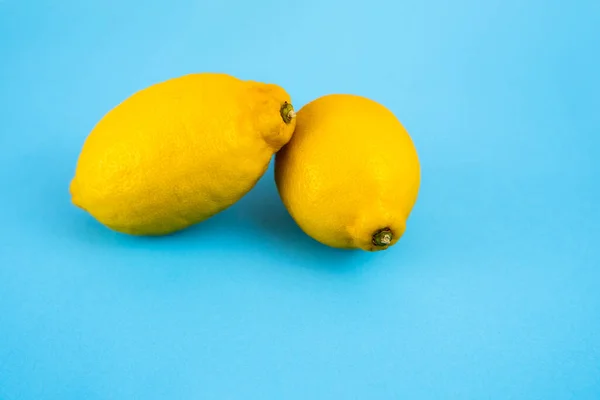 Pair of lemons on blue background