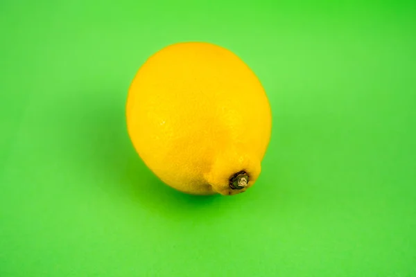 Singled out lemon on green background