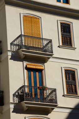 İki pencereli ve balkonlu eski bina cephesi. Valencia, İspanya