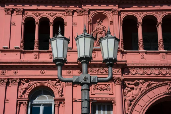 Old street lamp with the Pink House (Casa Rosada) also known as Government House (Casa de Gobierno) in the background. Buenos Aires, Argentina