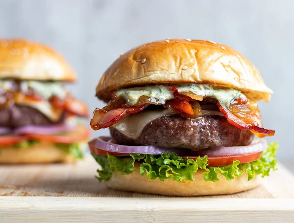 beef burgers and meat on wooden background