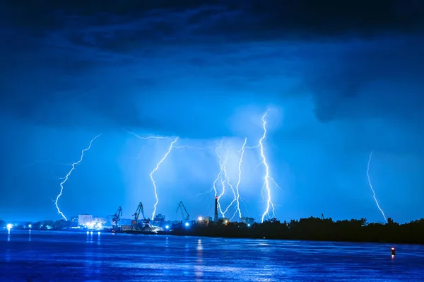 Thunderstorm with lightning in the port city by the river