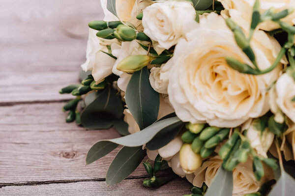 Brides fees. Bouquet of the bride in her hands before the ceremony. High quality photo