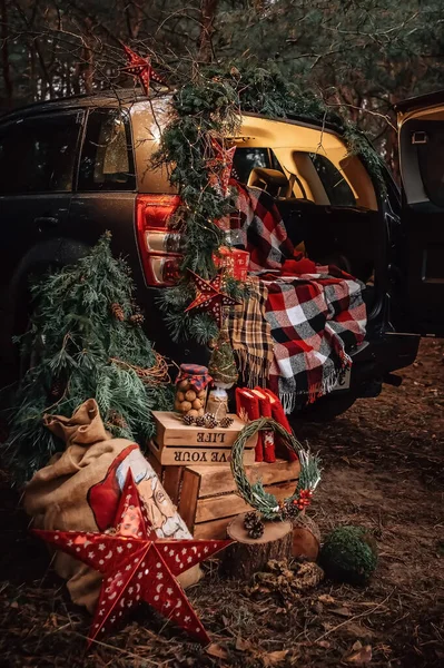 Christmas gifts in the winter forest by car. High quality photo