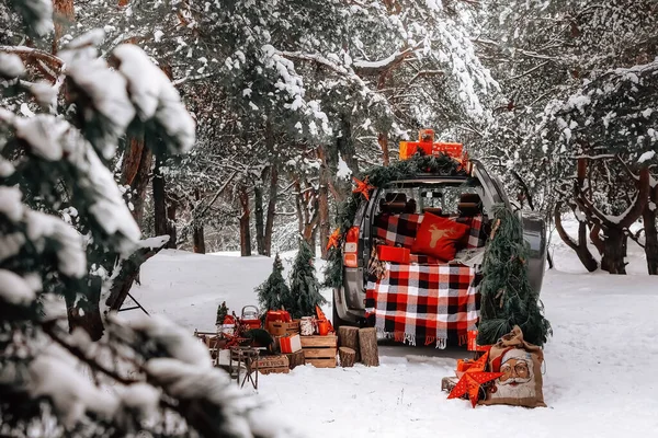 Christmas gifts in the winter forest by car. High quality photo