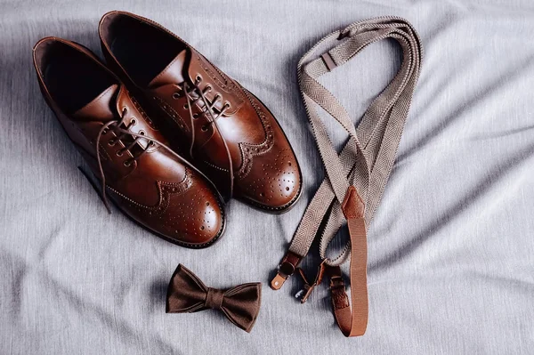 Wedding accessories of the groom before the wedding. Shoes, Suspenders, Bowtie. High quality photo