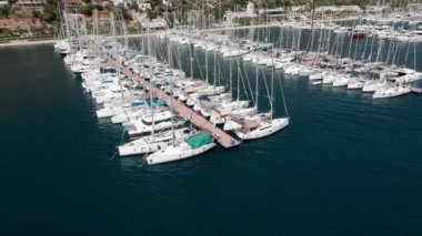 Marinadaki tekne ve yatların yukarıdan görünüşü. Yat park yeri, yat ve yelkenli iskeleye demirlenmiş, hava aracı ile hava manzaralı. Lefkada Adası